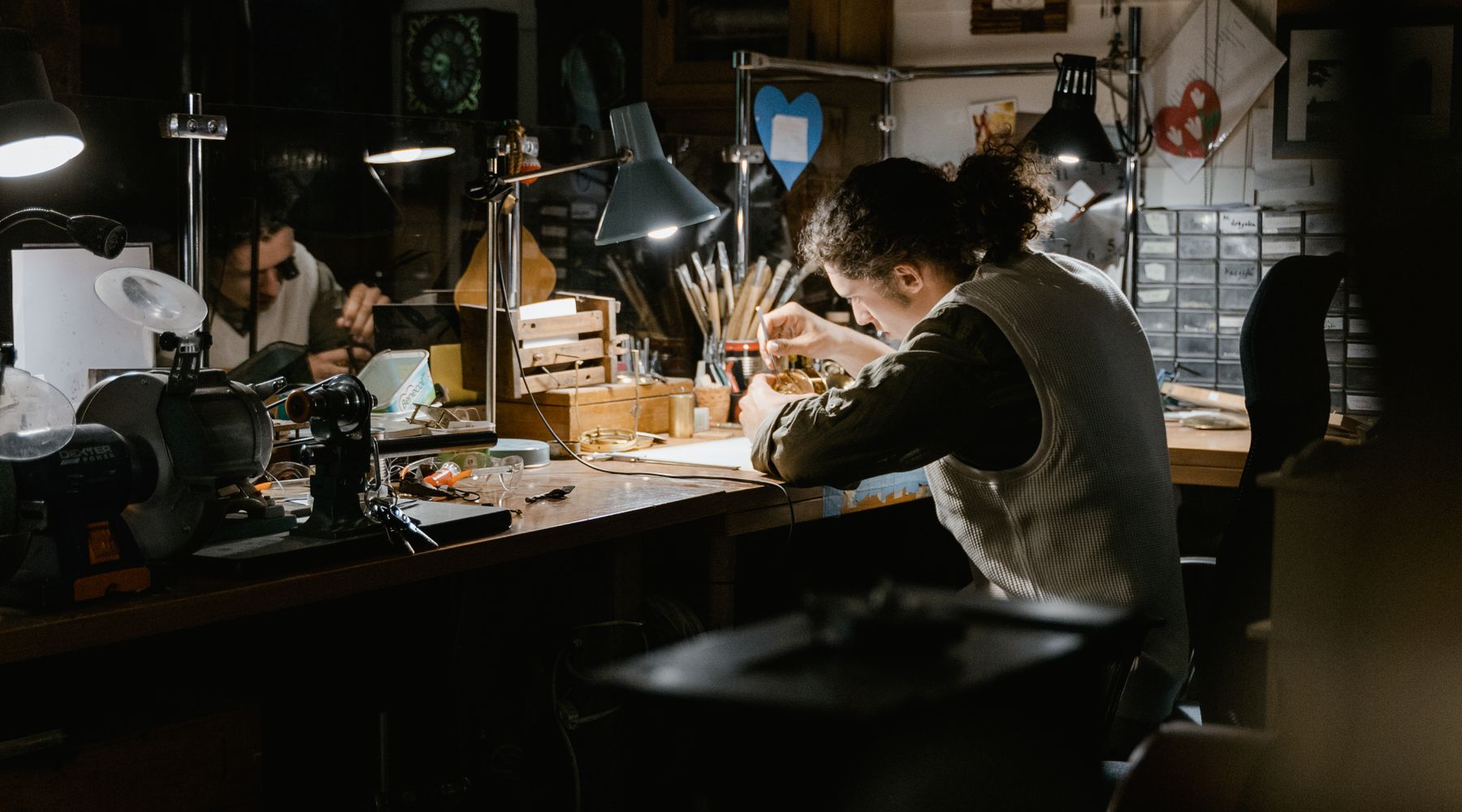 Watchmaker inspecting a movement through a loupe